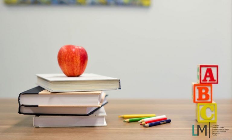 Teacher table books crayons blocks & LM Abogados logo