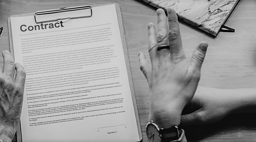 Hands over contract on table