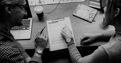 Man and woman look at contract